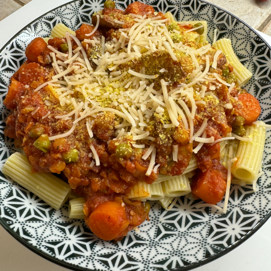 Vegan Lentil Bolognese with mushrooms, sweet peas, and carrots