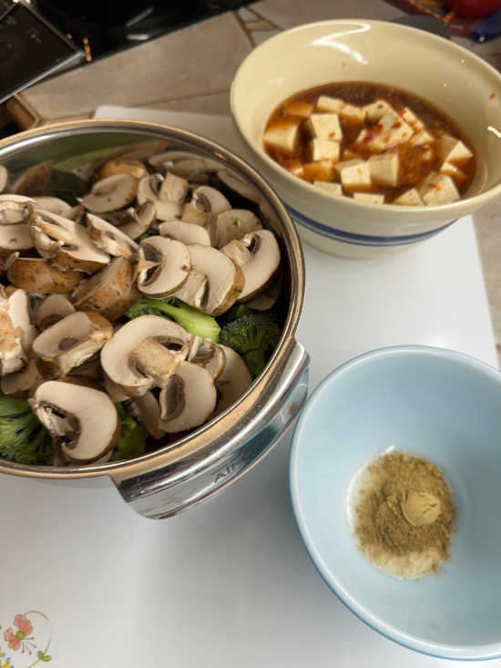 Marinating tofu, chopped vegetables, and combined spices in three separate bowls