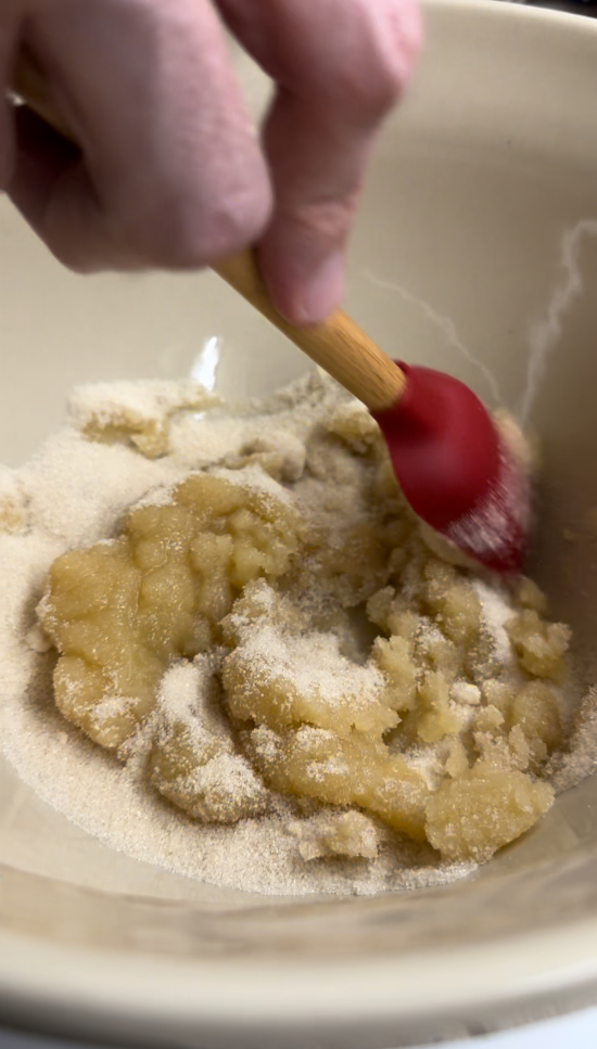 Applesauce and sugar being mixed together