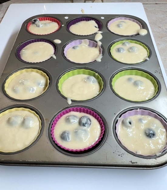 Blueberry muffin batter added to cupcake pan