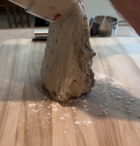 Adding dough to floured surface