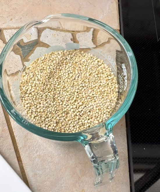 White quinoa in measuring cup