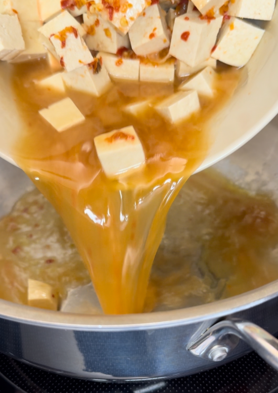 Adding the tofu to the skillet