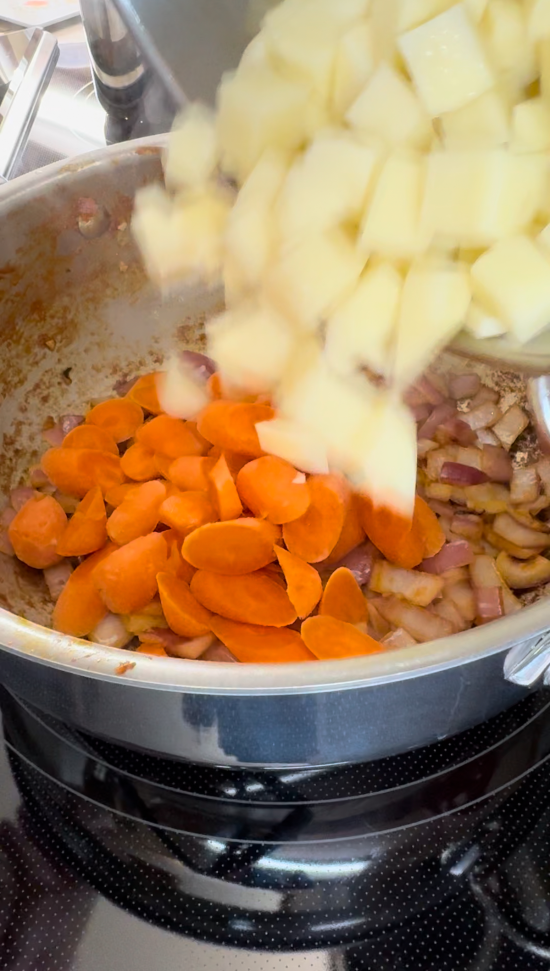 Carrots and potatoes added to skillet