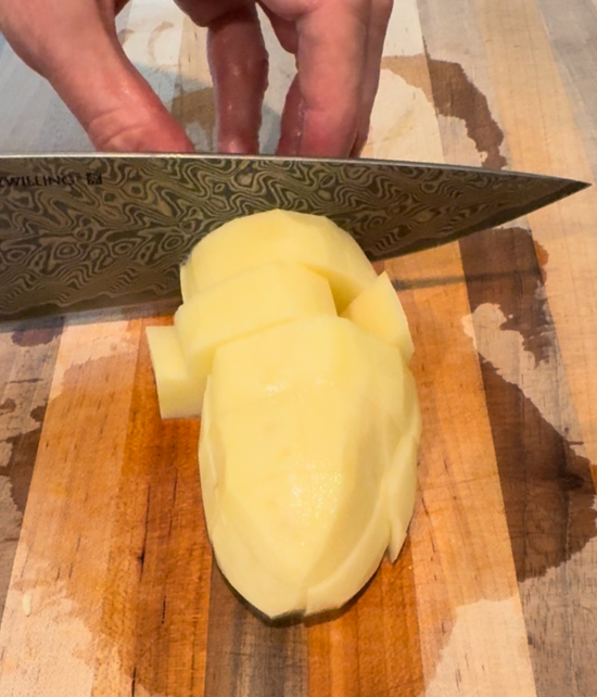 Cubing a peeled Russet potato