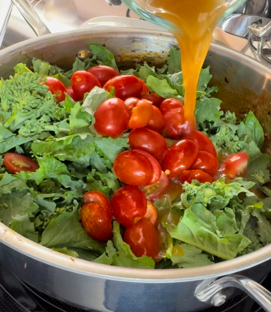 Adding the cherry tomatoes and veggie stock