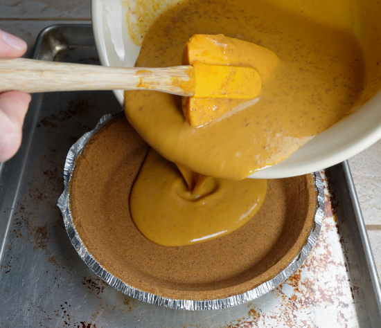 Filling pie shell with sweet potato pie filling