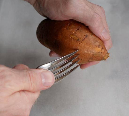 Pierce sweet potatoes with a fork