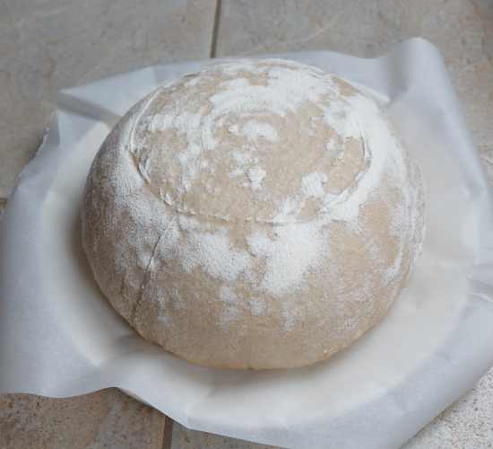 Sourdough on parchment paper ready to be scored