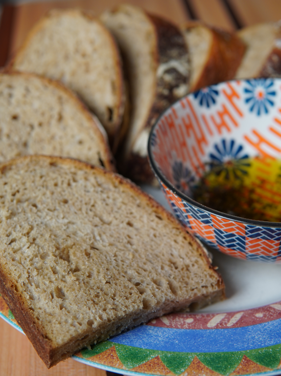 Whole wheat sourdough ready to eat with olive oil as a side