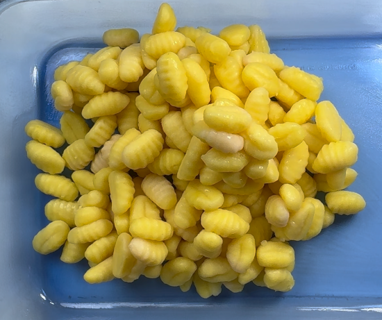 Cooked gnocchi added to the baking dish