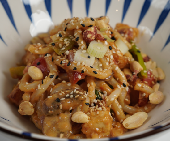 Peanut Udon Noodle Stir Fry with green onions, sesame seeds, and peanuts