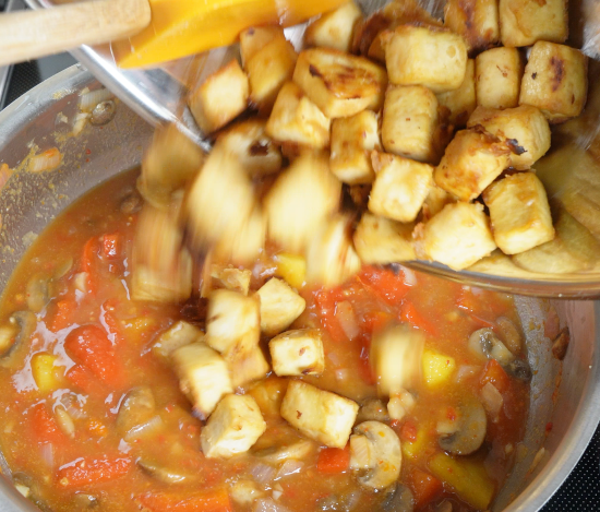 Adding the baked tofu to the dish