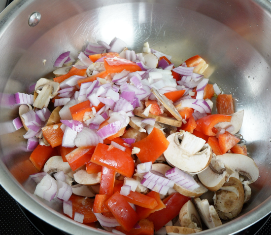 Mushrooms, bell pepper, onion, and garlic added to the skillet