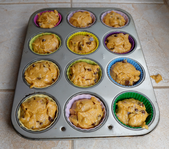 Lined cupcake pan with batter ready to bake