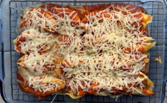 Baked stuffed shells with melted cheese fresh from the oven