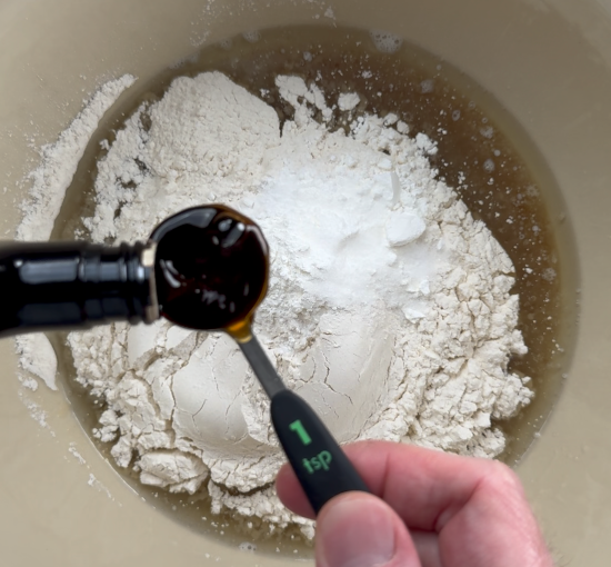 Adding vanilla extract to dry ingredients. 