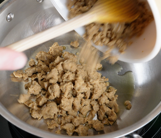 Removing the cooked seitan from the skillet