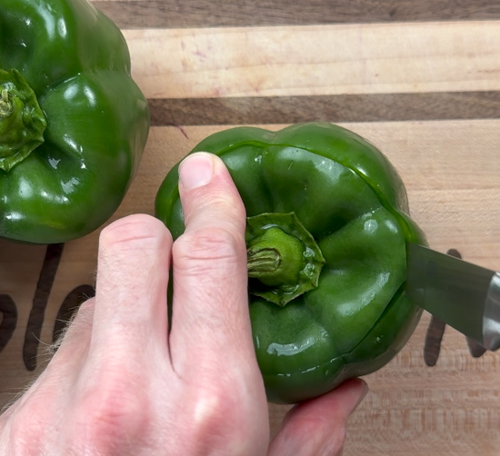 Cutting the tops off the bell peppers