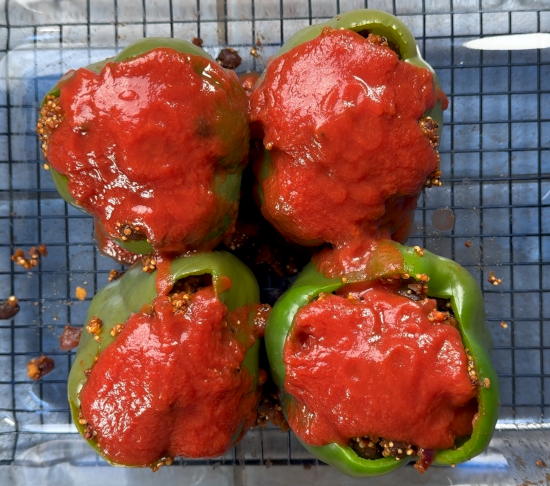 Tomato sauce added to the tops of the bell peppers to help keep the moisture in the filling. 