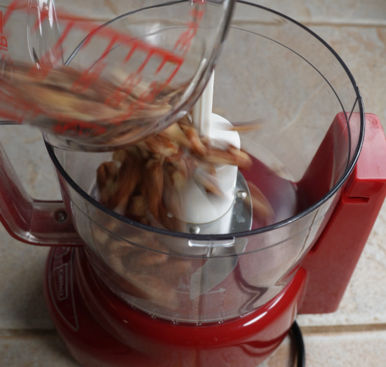 Adding pecans to a food processor