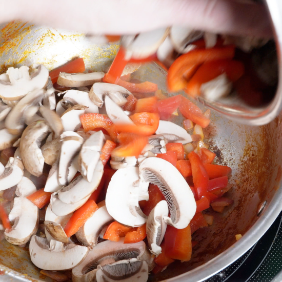 Cooking the red bell pepper and mushrooms