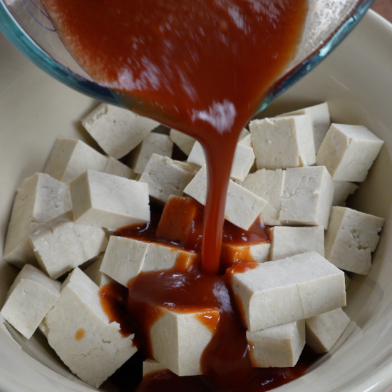 Adding the marinade to the tofu