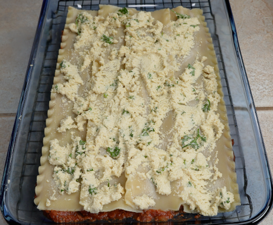 Cashew ricotta added to the baking dish