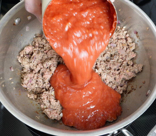 Adding crushed tomatoes