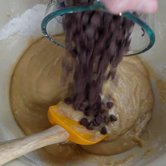 Adding the chocolate chips to the cookie dough