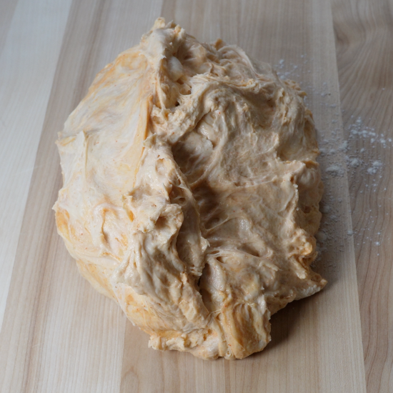 Dough on lightly floured bread board ready to shape