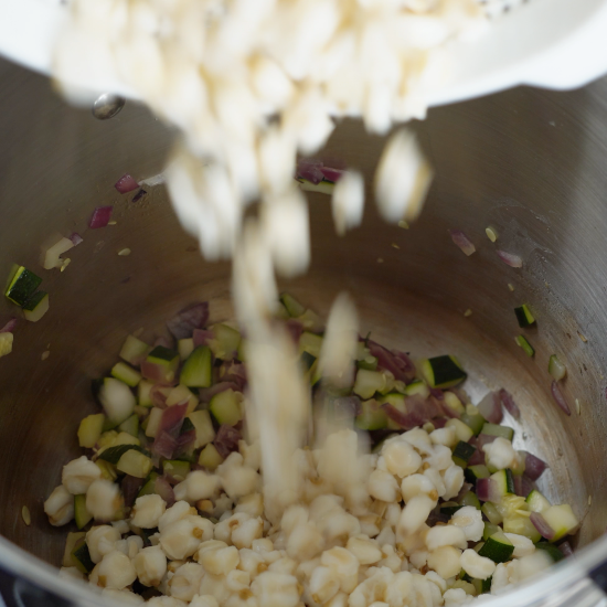 Hominy being added to the soup pot