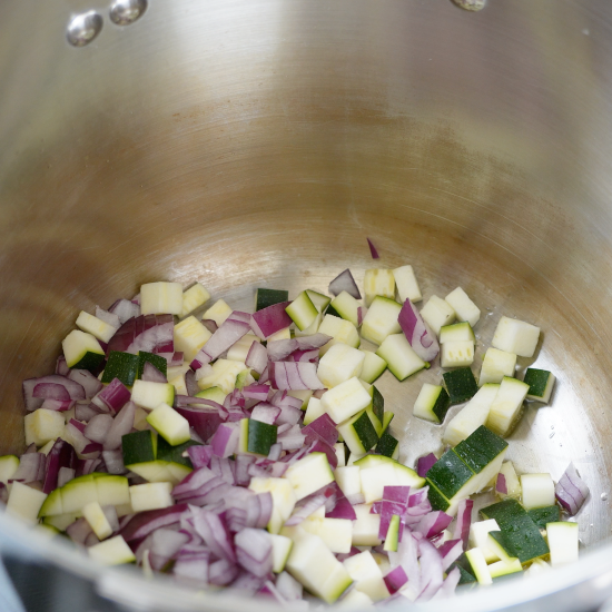 Zucchini and onion in the soup pot