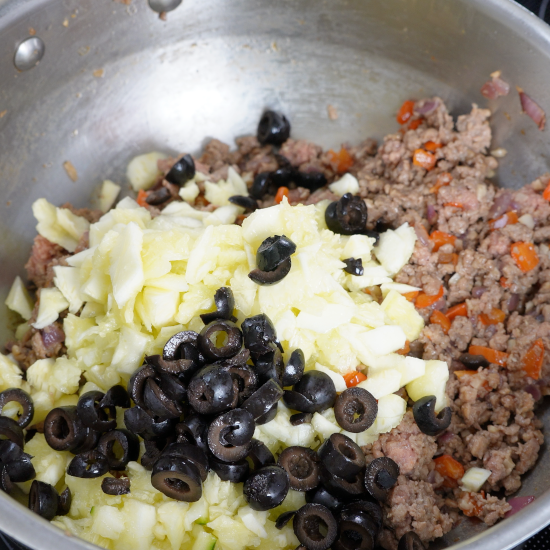 Zucchini and olives added to the skillet