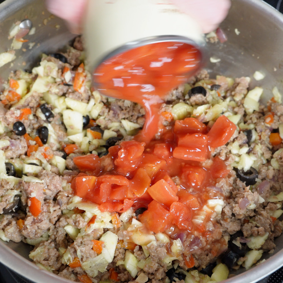 Diced tomatoes added to the skillet