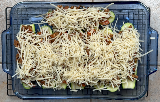 The zucchini boats are covered in vegan cheese