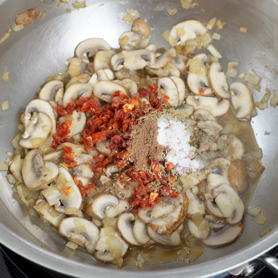 Adding the sun-dried tomatoes and spices