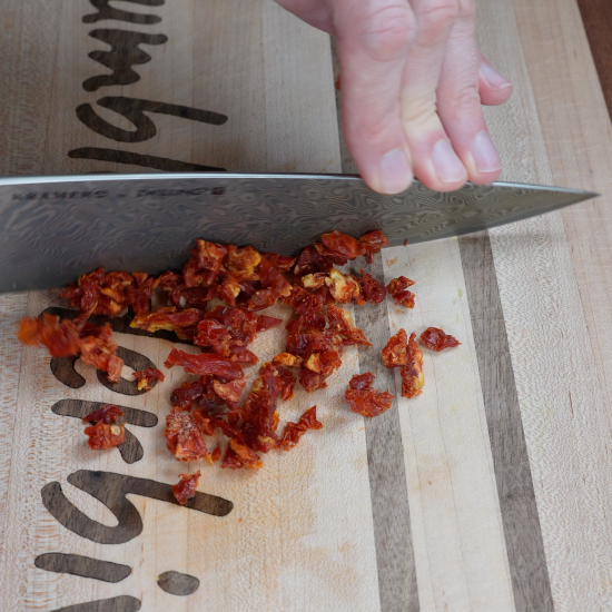 Chopping sun-dried tomatoes 