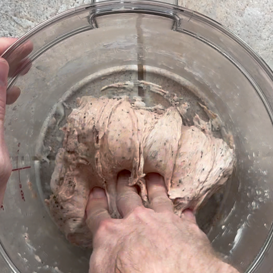 Performing a stretch and fold on the dough