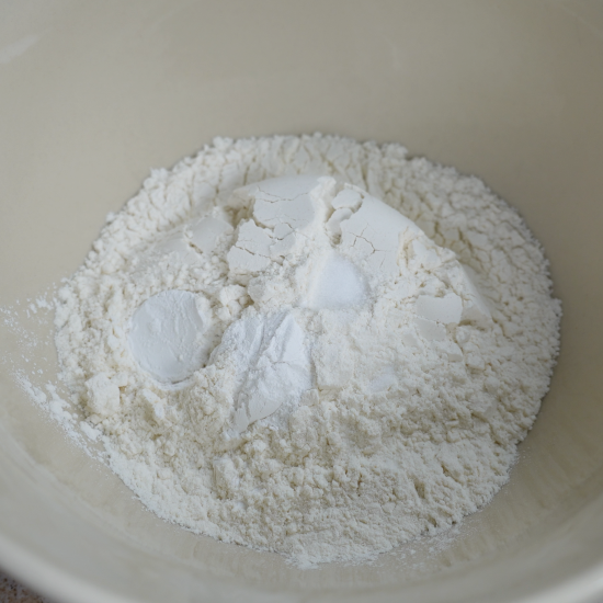 Biscuit dough dry ingredients added to a mixing bowl