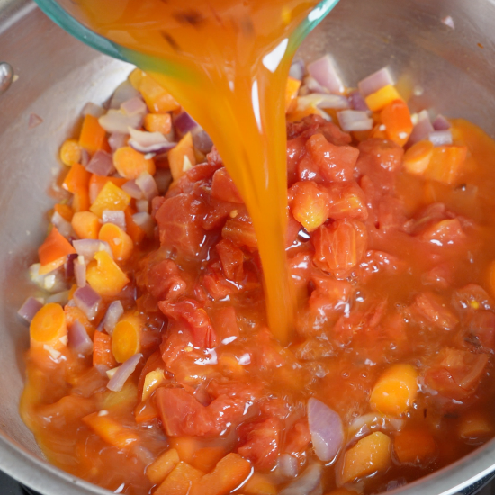 Adding the vegetable stock to the skillet