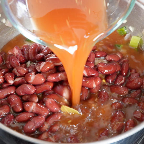 Adding the seasonings and liquid to the pan