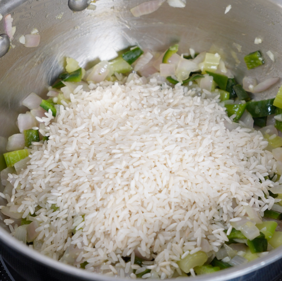 Added the white rice to the pan