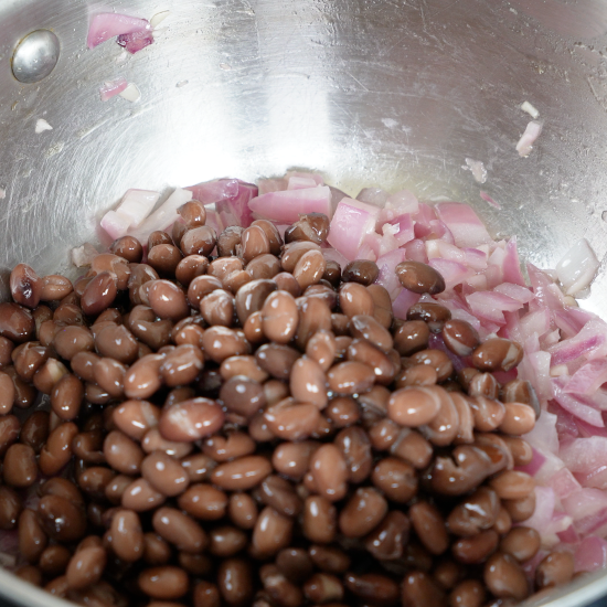 Added the drained black beans to the pan