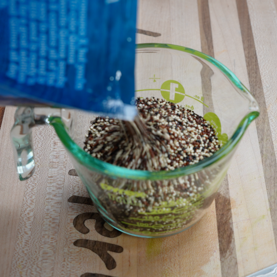 Measuring the quinoa for this dish in a measuring cup