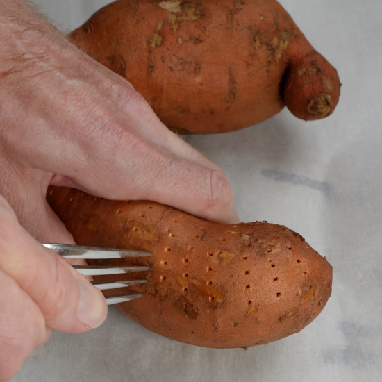 Carefully pierce the sweet potato with a fork. Then bake at 425 degrees Fahrenheit for 45-60 minutes. 