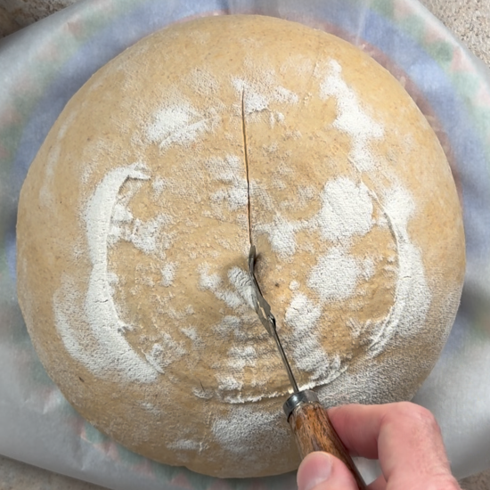 Using a bread lame to score the dough